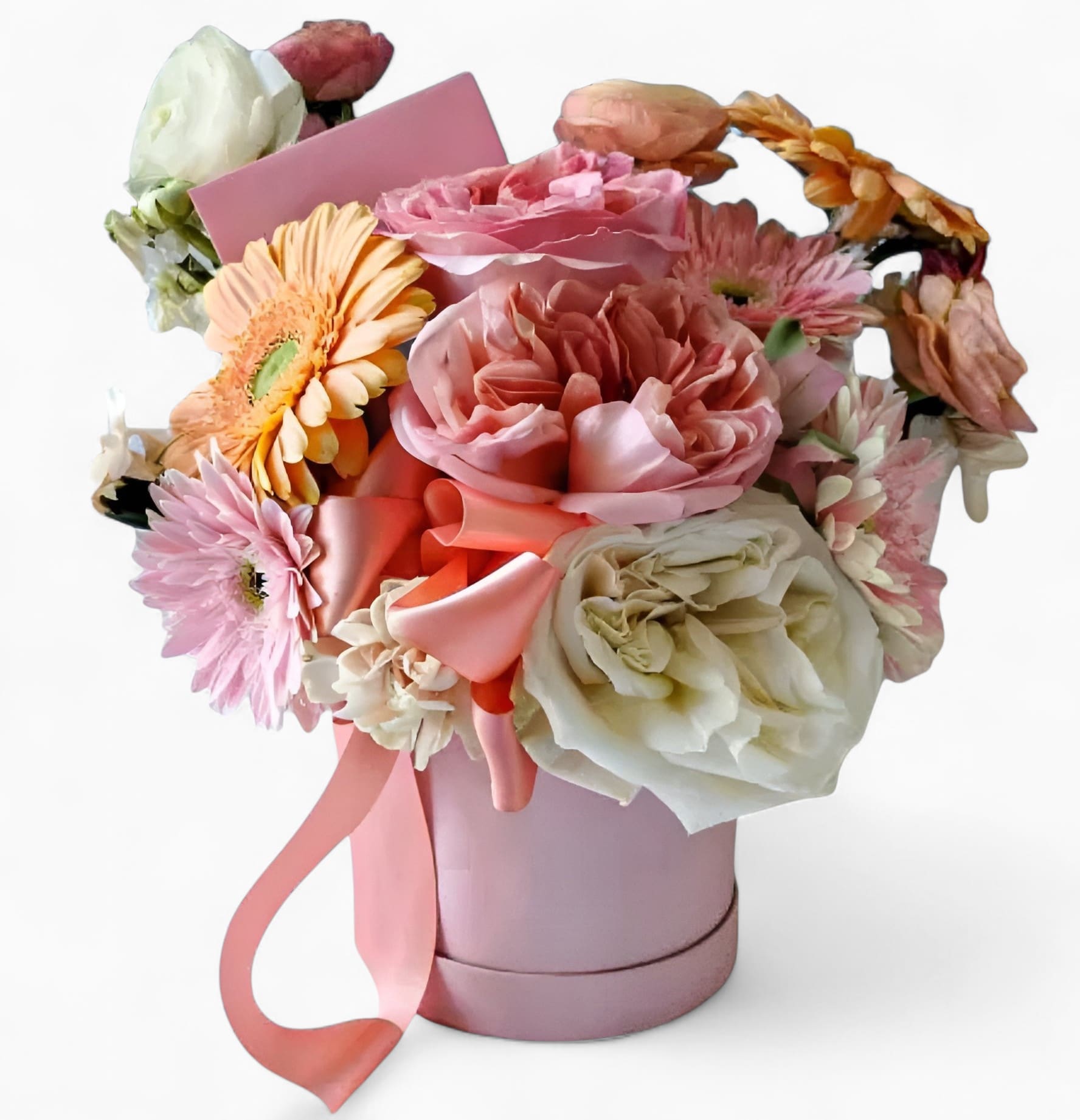 Pink and white mixed flowers arranged in a pink hatbox with a satin ribbon and card