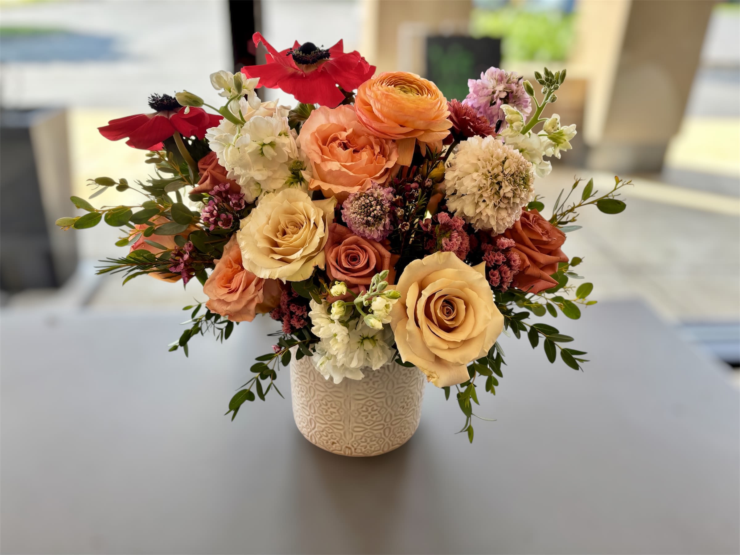 The Emilia | Garden Inspired - The Karima is a garden-inspired arrangement with natural movement, texture and timeless elegance. Designed in our signature boutique style, each arrangement feels gathered, artistic and thoughtfully composed.  Every arrangement is created by our floral studio using the freshest flowers available. Your arrangement will be inspired by the overall style, size and design shown. Exact flower varieties and colors will vary based on seasonal and market availability while preserving the beauty, value and character of the arrangement.  Perfect for birthdays, anniversaries, celebrations, housewarmings or simply brightening someone's day.  To keep your flowers looking their best, refresh the water every 2–3 days and keep the arrangement away from direct heat, sunlight and drafts.  A Ray of Sunshine Floral proudly delivers flowers throughout Hilliard, Dublin, Upper Arlington, Grandview Heights and surrounding Columbus communities.