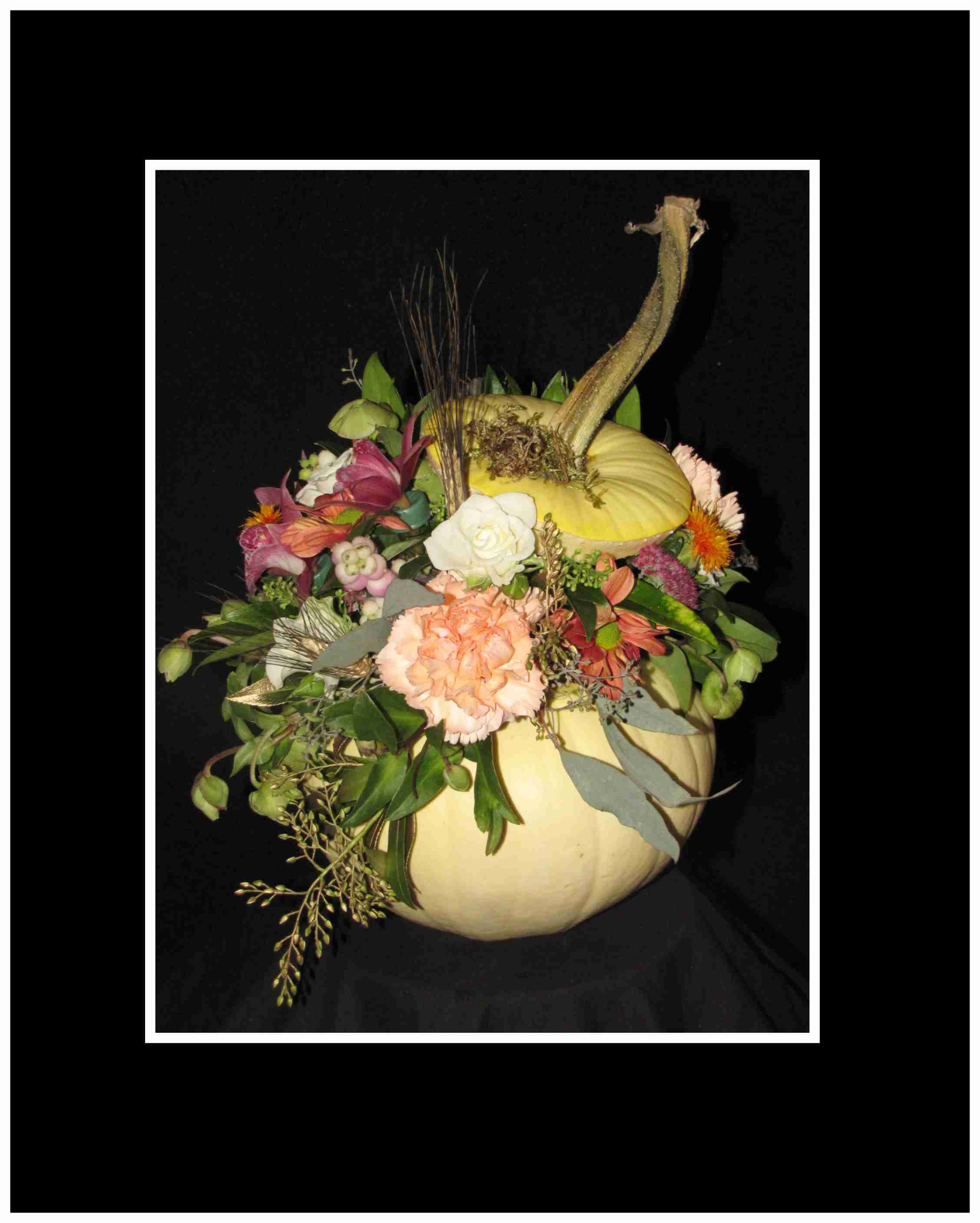 Before Midnight Arrangement - This fresh white ghost pumpkin is filled with spray roses, mini carns, spray mums, sedum assorted greens and eucalyptus a wonderful fall table piece that's just for fun and a novelty  Approximately 12"H x 12