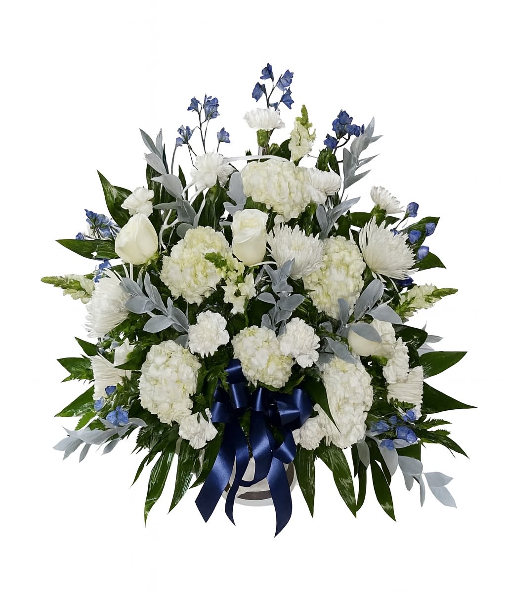 White floral spray with blue accents and a navy ribbon