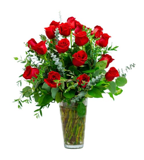 Red roses arranged in a clear glass vase