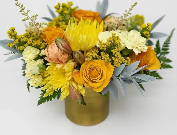 Yellow and orange bouquet in a gold vase
