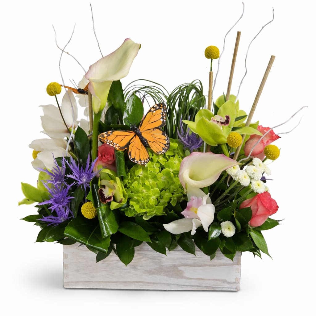 Garden Bliss Box - Bring the beauty of a blooming garden indoors with our Garden Bliss Box. This charming arrangement is thoughtfully designed in a rustic wooden container and features a vibrant mix of fresh seasonal blooms in soft whites, fresh greens, pops of pink, and cheerful yellow accents.  With its lush textures and natural, garden-inspired style, this arrangement creates a refreshing and uplifting presence in any space. Perfect for birthdays, celebrations, or simply brightening someone’s day, the Garden Bliss Box delivers a touch of nature’s elegance with a modern twist.  Handcrafted with care, each design is unique—making every box a one-of-a-kind expression of floral beauty.