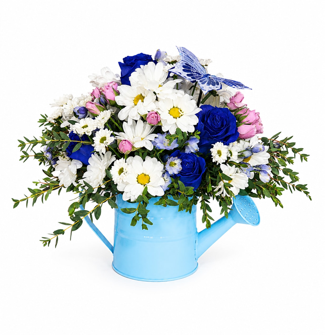 Blue Butterfly Bloom Watering Can - Bright, cheerful, and full of charm, the Blue Butterfly Bloom features stunning royal blue roses, crisp white daisies, soft pink spray roses, and delicate seasonal accents artfully arranged in a whimsical blue watering can container. Finished with lush greenery and a decorative butterfly touch, this garden-inspired arrangement is perfect for birthdays, thank-you gifts, celebrations, or simply brightening someone’s day with beauty and joy.