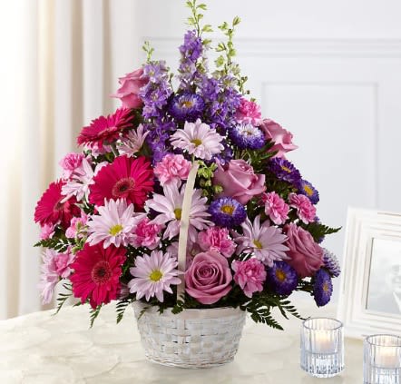 Pastel Peace Basket - The Pastel Peace Basket is a sweet and simple way to offer your condolences. Lavender roses, fuchsia gerbera daisies, lavender daisies, purple larkspur, purple matsumoto asters, pink mini carnations and lush greens are arranged to perfection in a round whitewash handled basket to create a gift that expresses your wishes for sympathy and peace. Details: Designed by florists, ready to display. For long–lasting blooms, add water daily. Pet Safety Precautions: This bouquet or plant may include flowers and foliage that are known to be toxic to pets. To keep them safe, be sure to keep this arrangement out of your pet's reach.