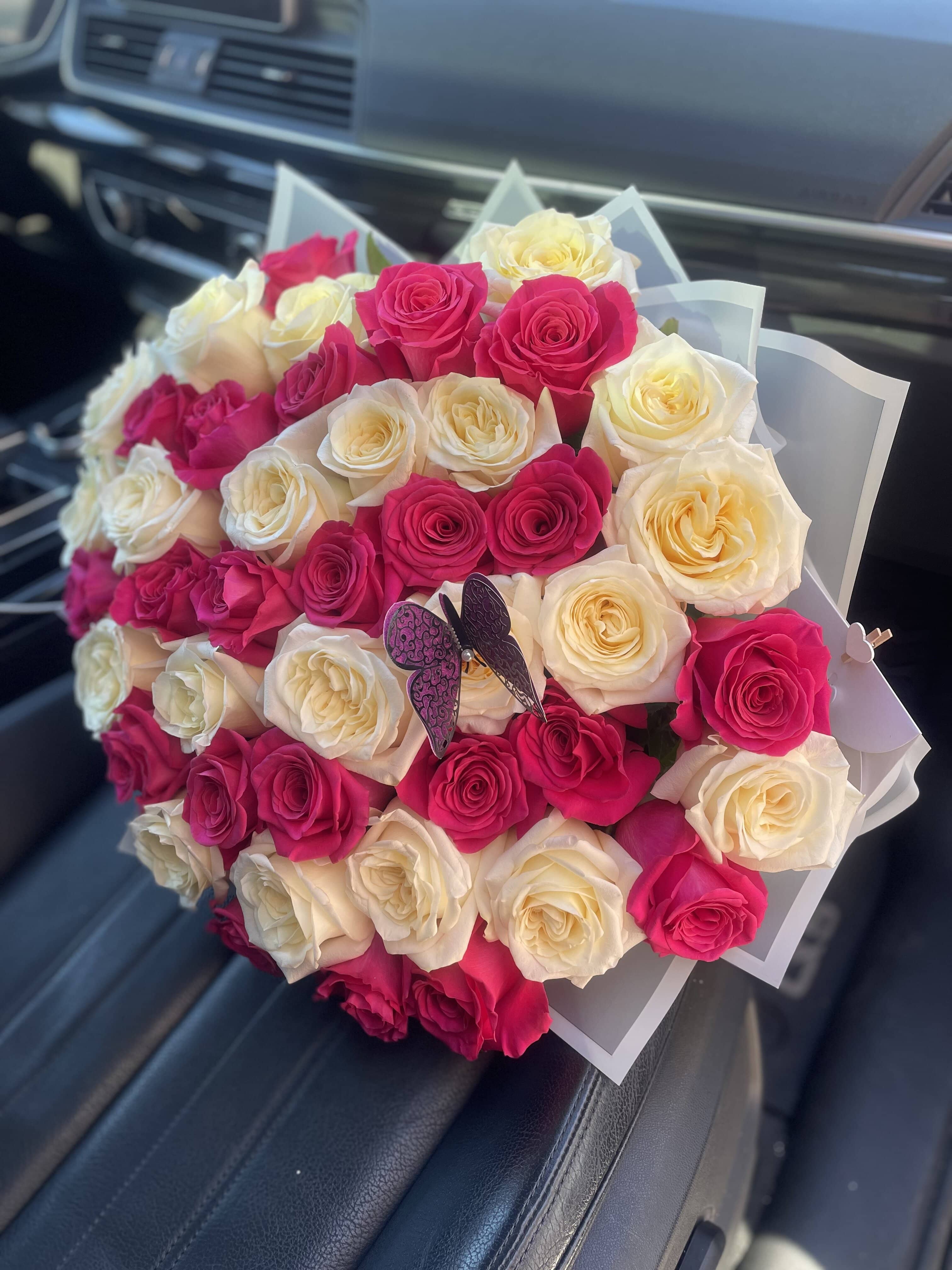 Bouquet of pink and cream roses with a butterfly decoration