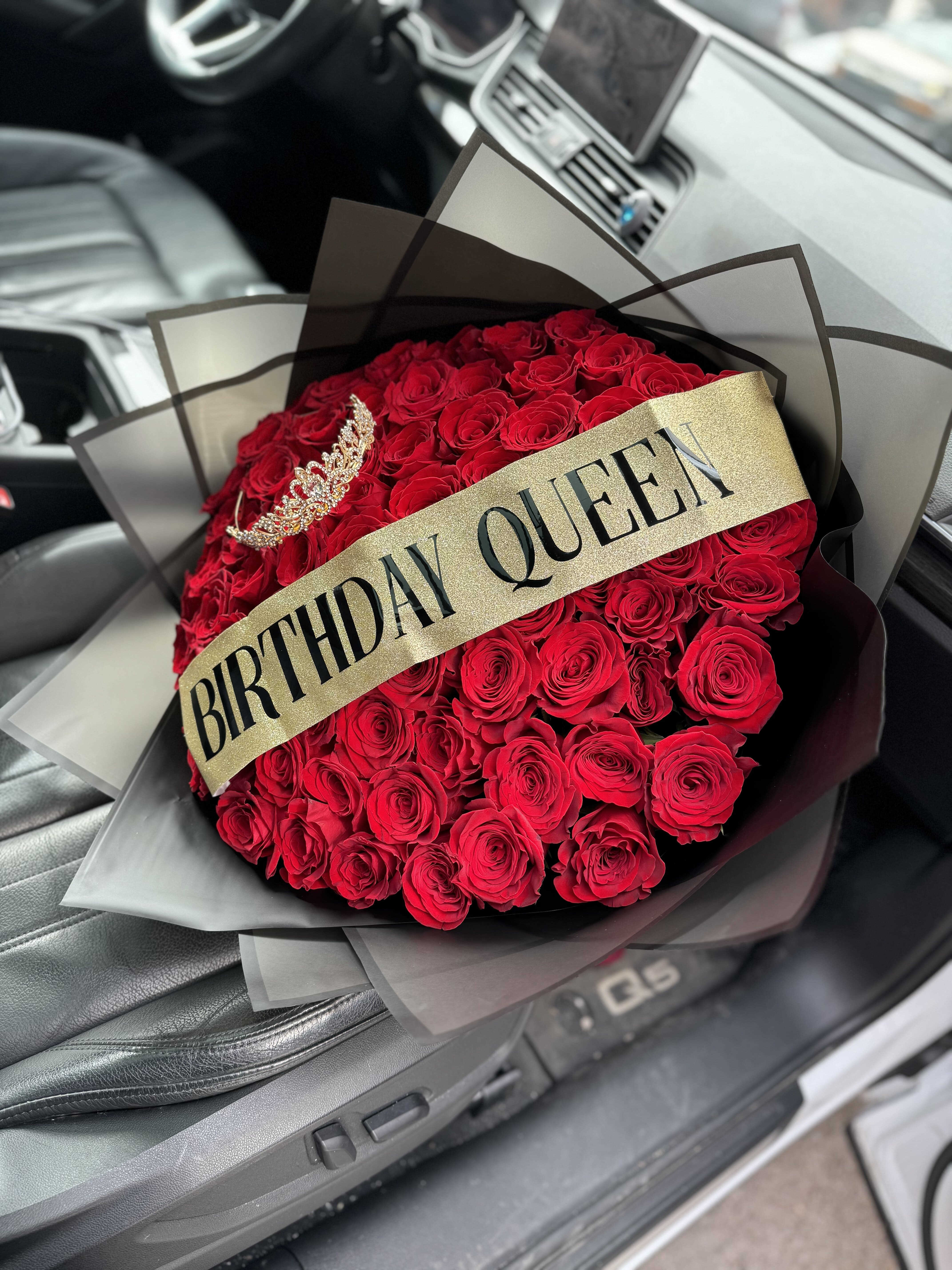 Bouquet of red roses with a birthday sash and tiara