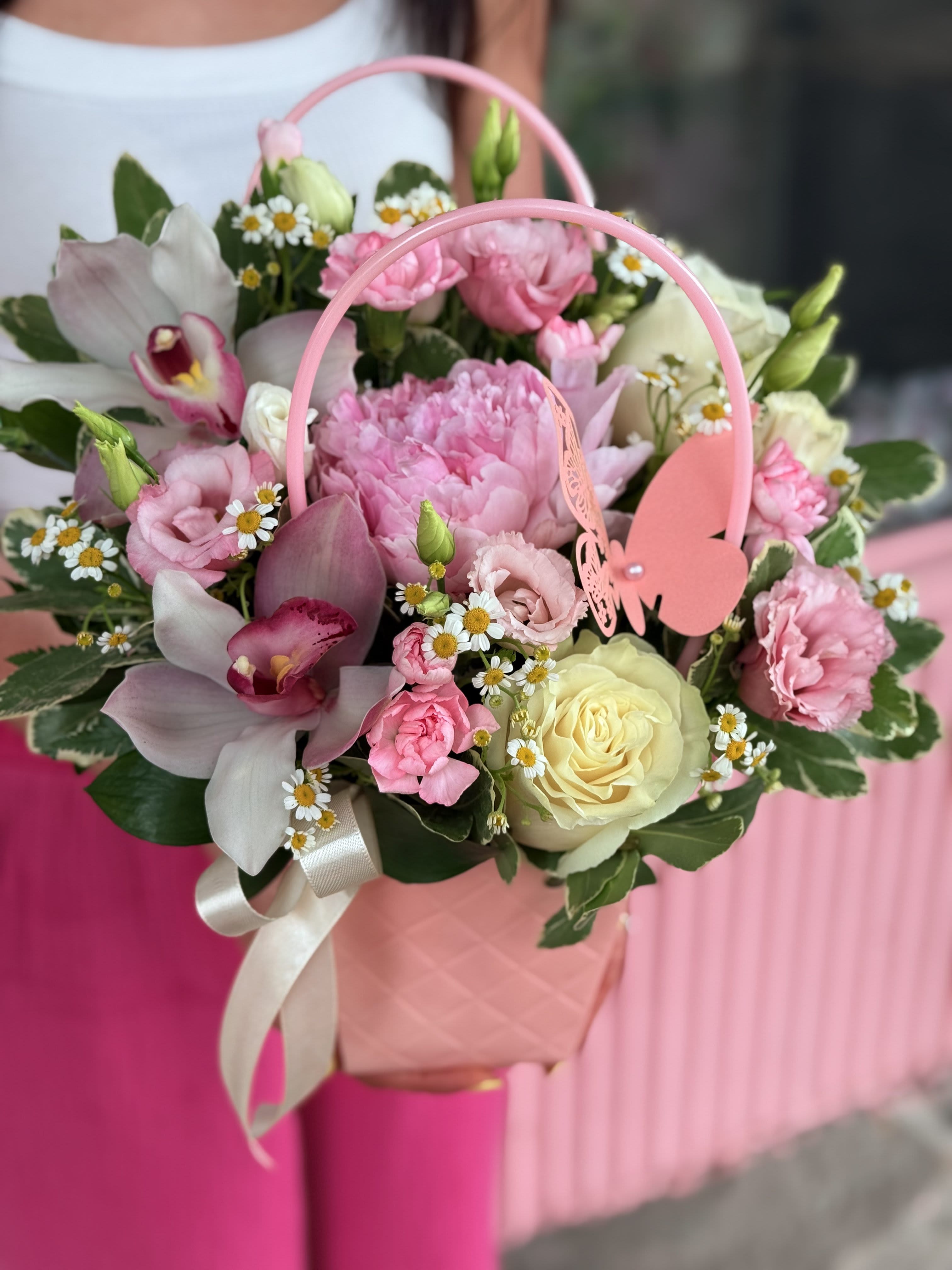 Pink floral basket with roses, orchids, and daisies