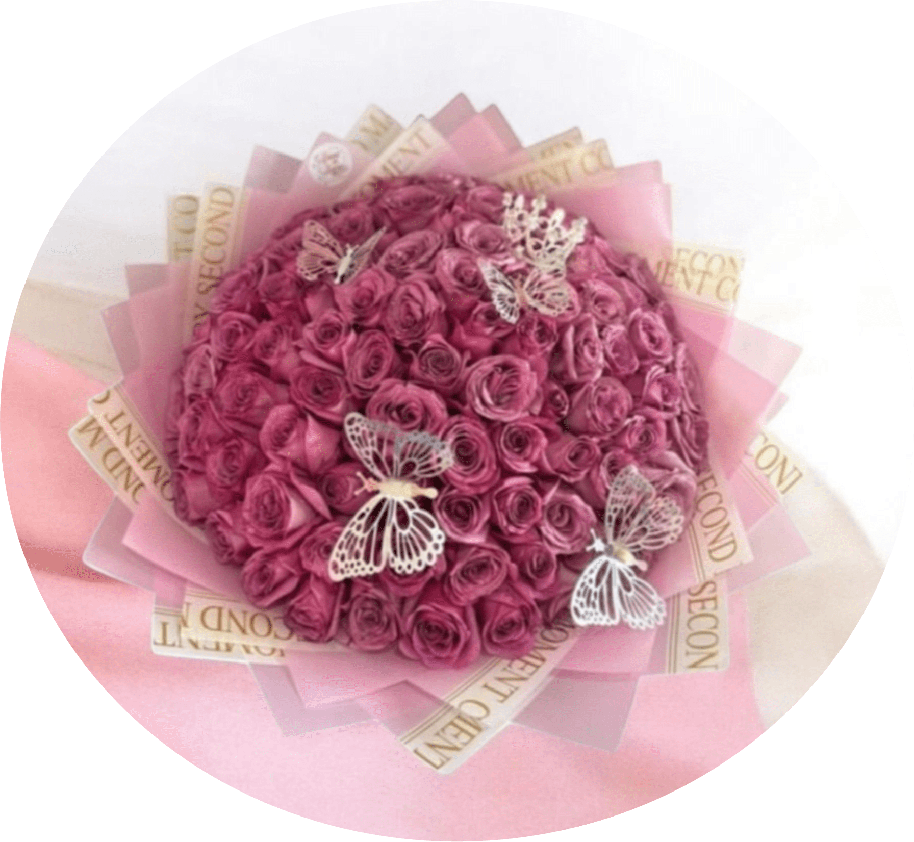 Sweet Dreams Pink Rose Bouquet with Butterfly Accents - A tightly packed dome of petite pink roses creates the first impression - soft, romantic, and instantly celebratory. This rose bouquet is designed as a love-and-romance or birthday floral gift, the kind that makes the person you're thinking of feel cherished: the cluster of small pink blooms reads intimate and feminine, while the translucent butterfly decorations add a whimsical, hopeful touch.  Wrapped in layered pink and cream decorative paper for a polished, boutique presentation, the arrangement sits as a compact, round gift-bouquet that's easy to carry and display. The dense texture of the miniature roses gives a plush, velvety look and the butterfly picks catch the light for added charm. Ideal for anniversaries, birthdays, or a sweet "thinking of you" surprise, this arrangement arrives ready to give - no vase required.