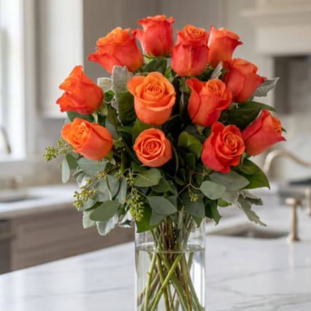 Bouquet of orange roses in a clear glass vase