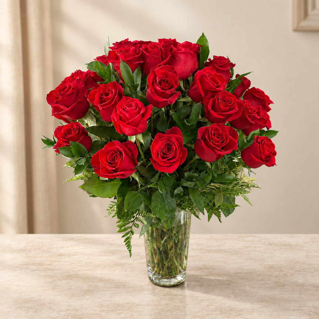 Red roses arranged in a clear glass vase