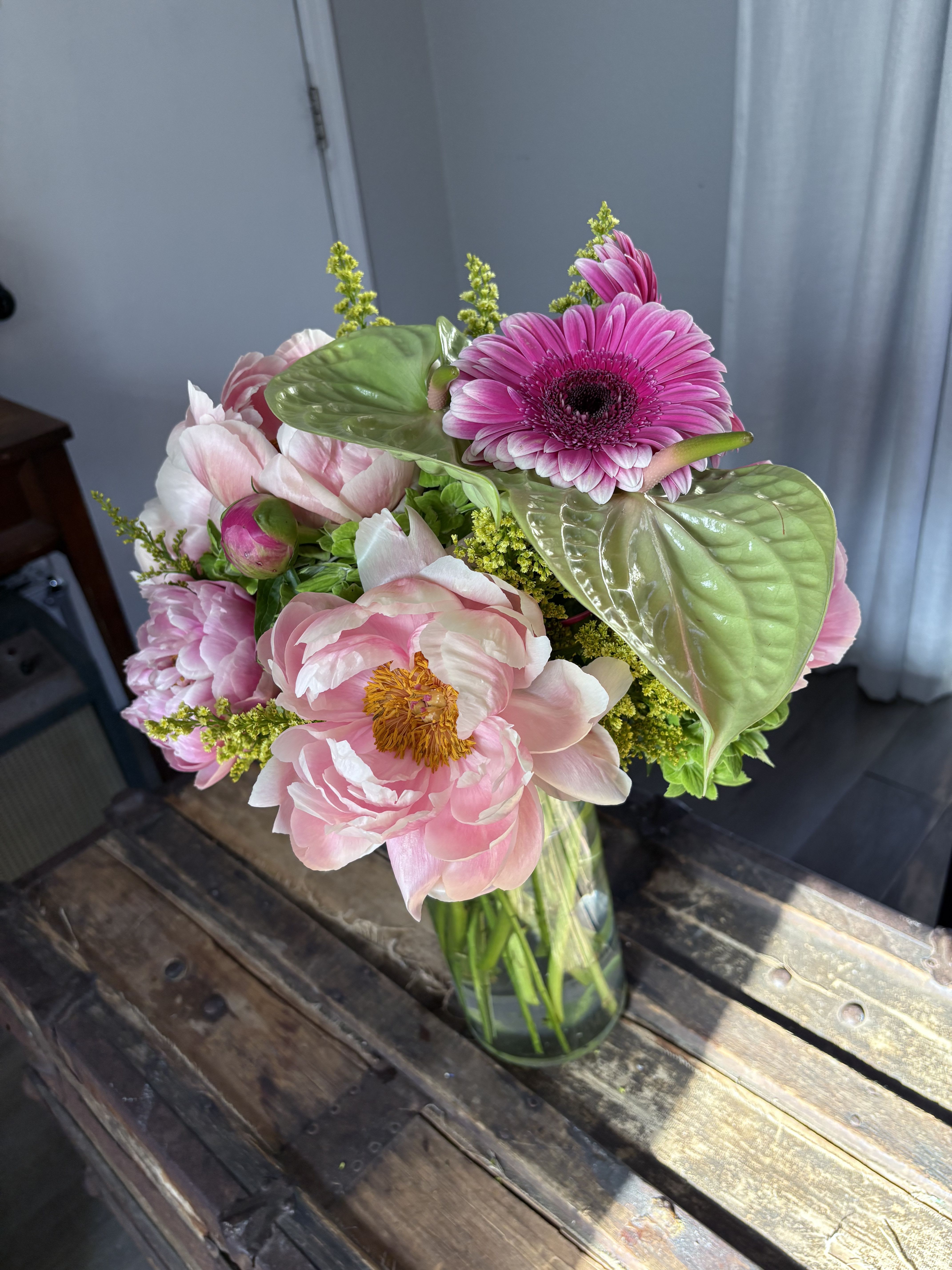 Pink and white bouquet in a glass vase with a bright pink gerbera daisy