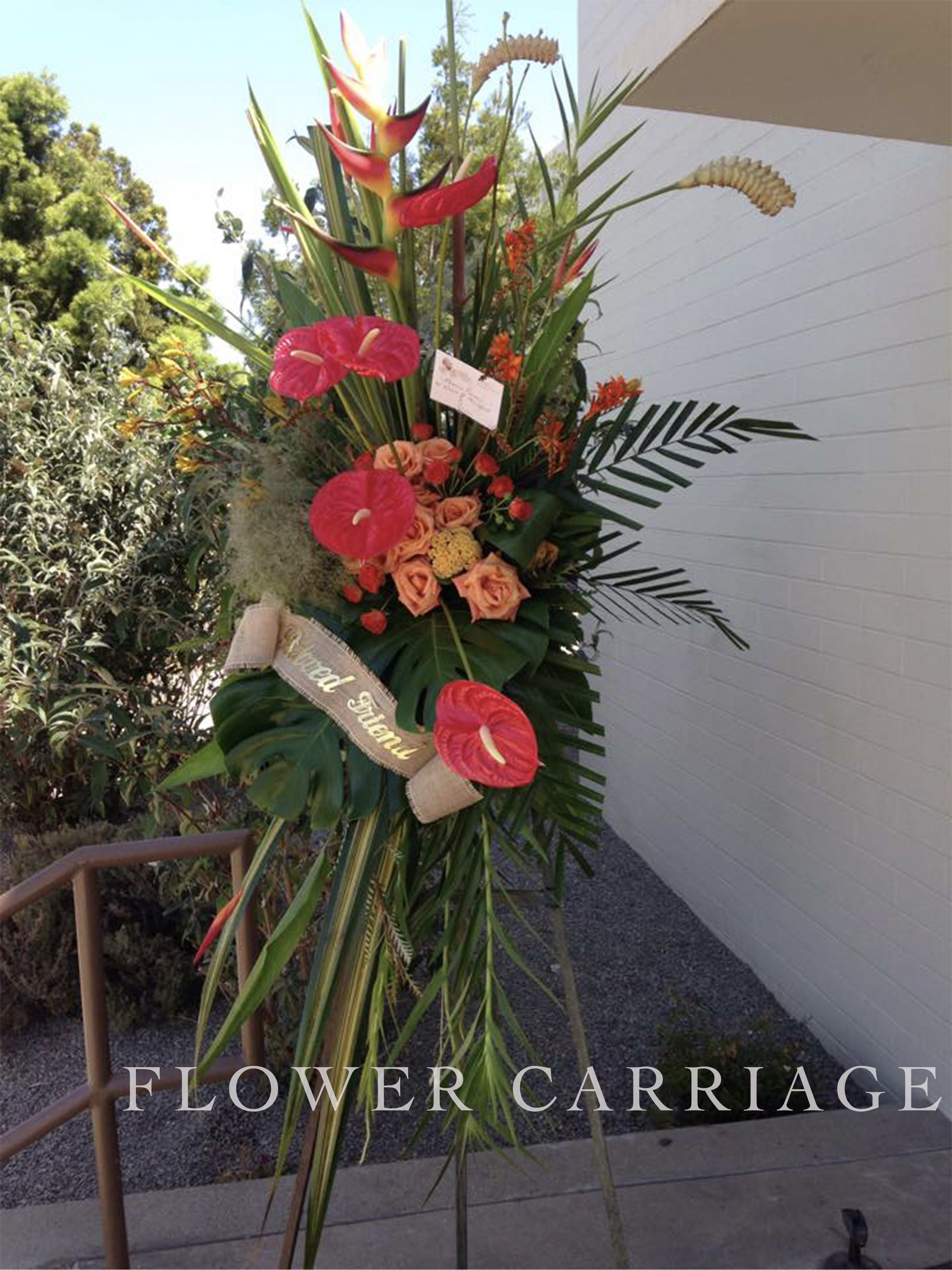 Tall tropical standing spray with pink anthuriums and orange roses