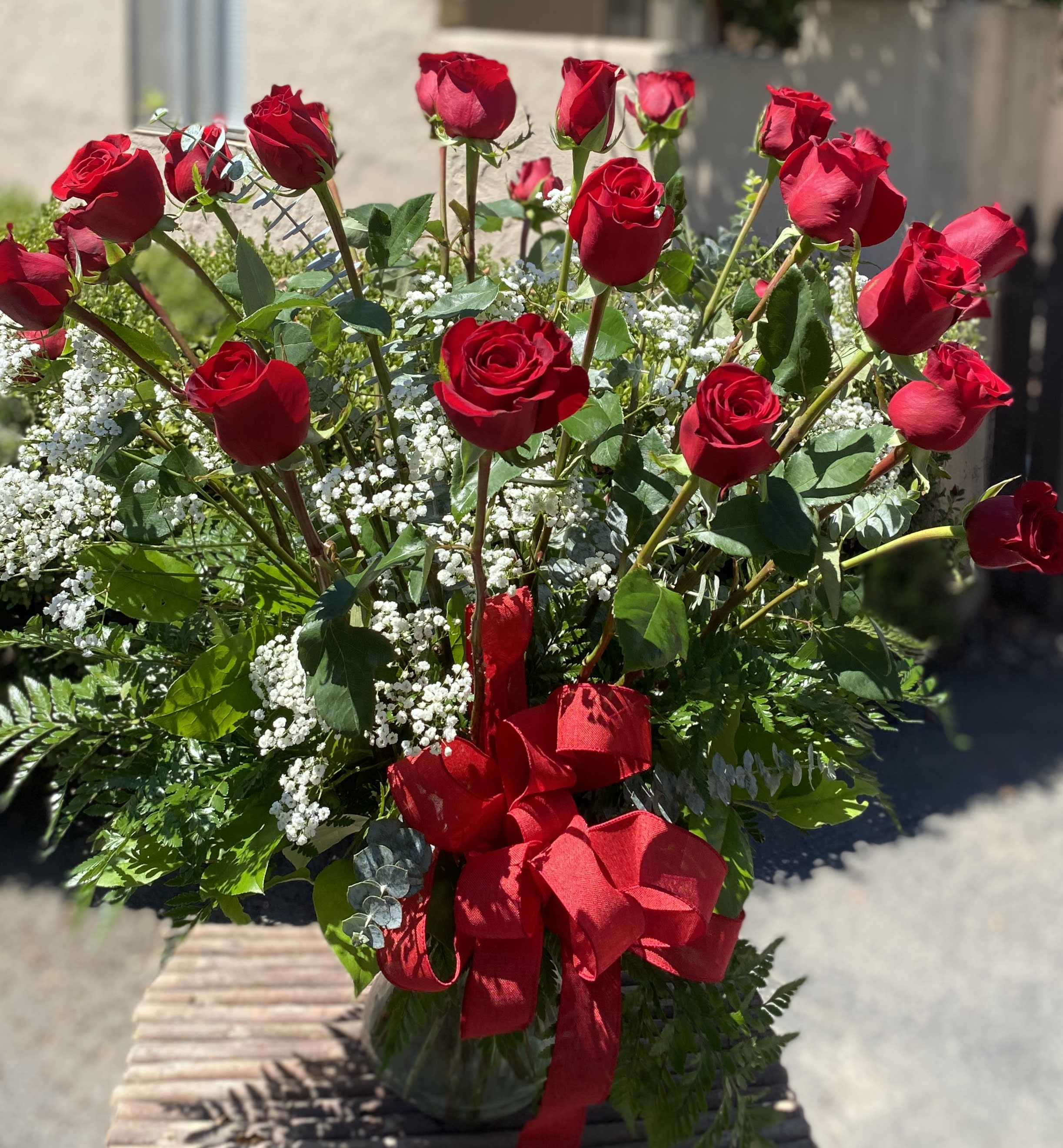 Bouquet of red roses with baby's breath and a red ribbon