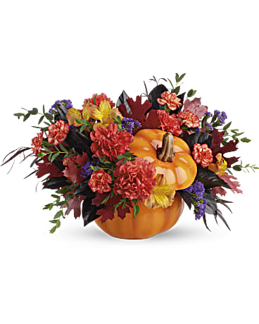 Hauntingly  Pretty Pumpkin - Add a hauntingly beautiful touch to your fall festivities with this magnificent mix of autumnal alstroemeria and carnations, gathered in a glazed ceramic pumpkin that's sure to be an annual décor favorite! This bouquet features orange alstroemeria, dark orange carnations, miniature orange carnation, purple sinuata statice, parvifolia eucalyptus, red agonis, and lemon leaf. Trick &amp; Treat Pumpkin. Orientation: All-Around 