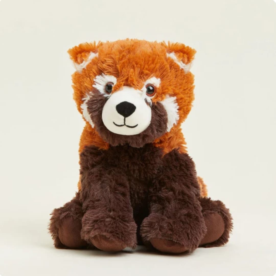 Plush red panda teddy bear sitting against a plain background
