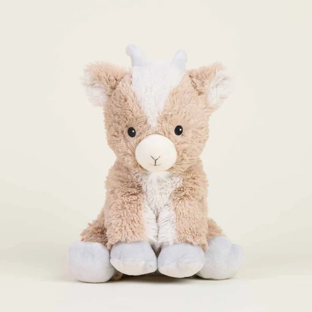 Plush stuffed animal with tan and white fur sitting against a plain background