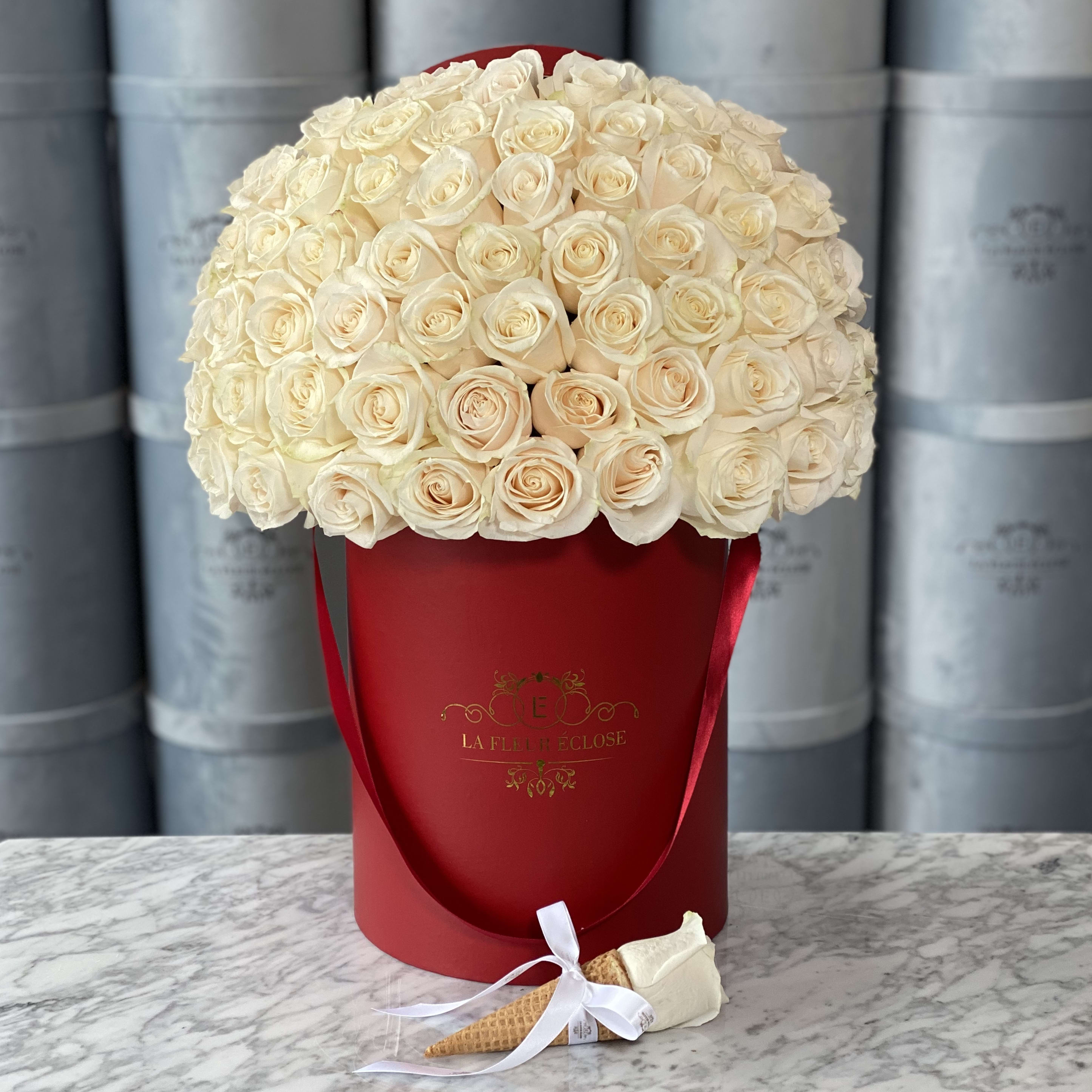 50 Pale White Roses in Our Signature Box - Standard includes 50 roses in our signature box. Deluxe includes 75 roses in our signature box. Premium includes 100 roses in our signature box. Available colors for our signature boxes are; Red, White, &amp; Black. Standard shown in photo