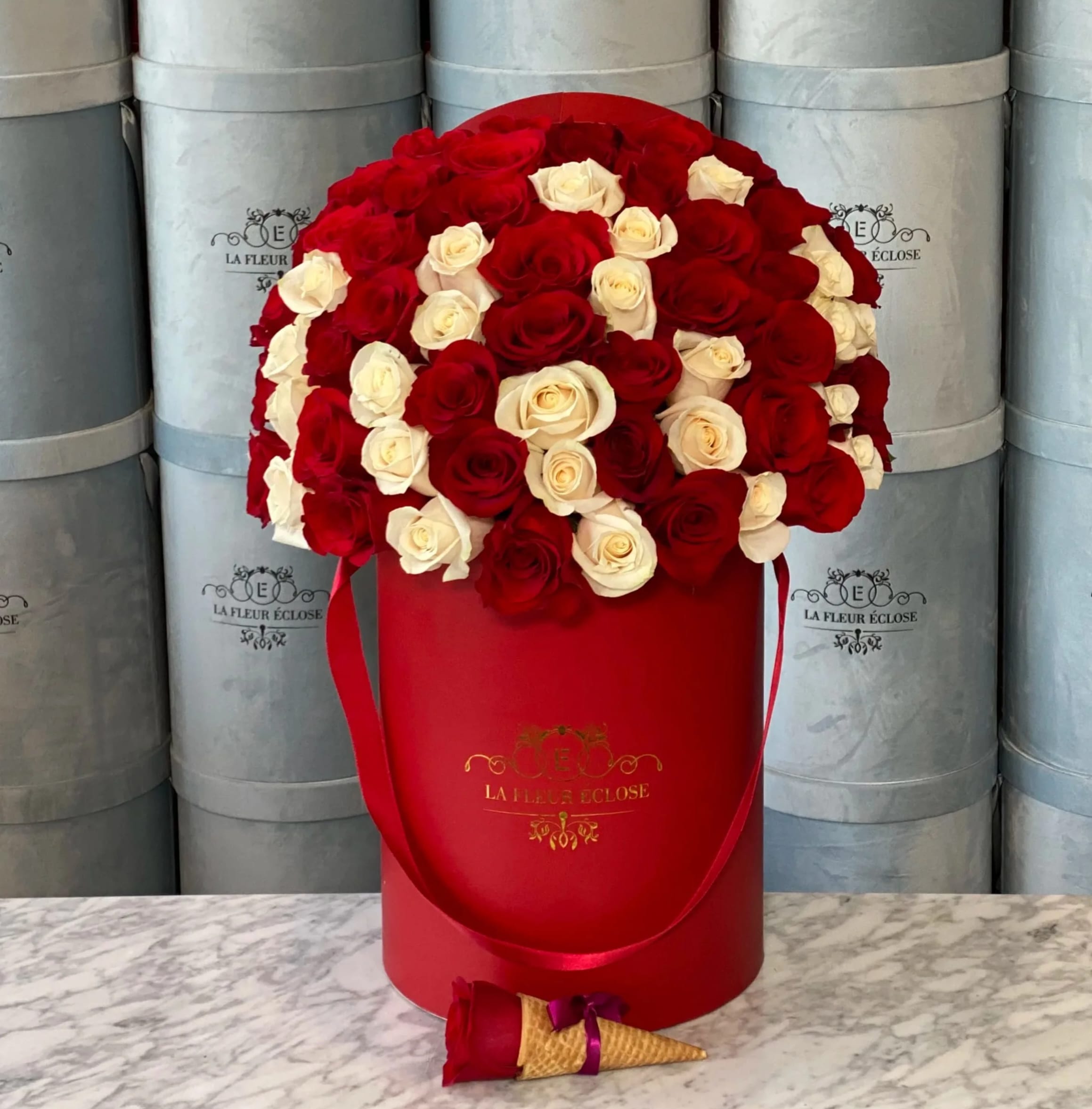 White And Red Roses In Our Red Signature Box  - Standard includes 50 roses in our signature box. Deluxe includes 75 roses in our signature box. Premium includes 100 roses in our signature box. Available colors for our signature boxes are; Red, White, &amp; Black. Standard shown in photo