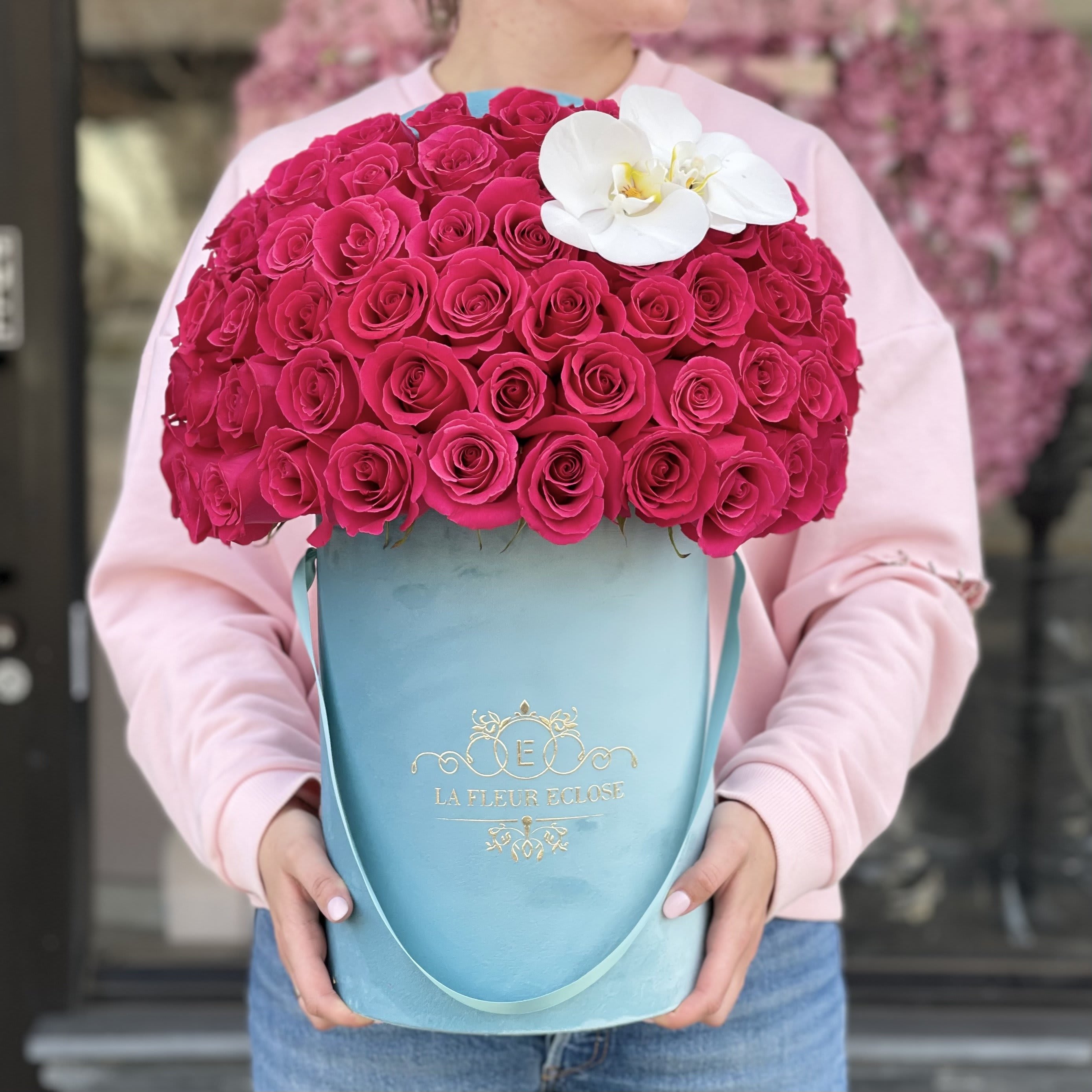 Turquoise with Orchid MD - Standard 50 hot pink roses in our signature turquoise box Deluxe 75 hot pink roses in our signature turquoise box
