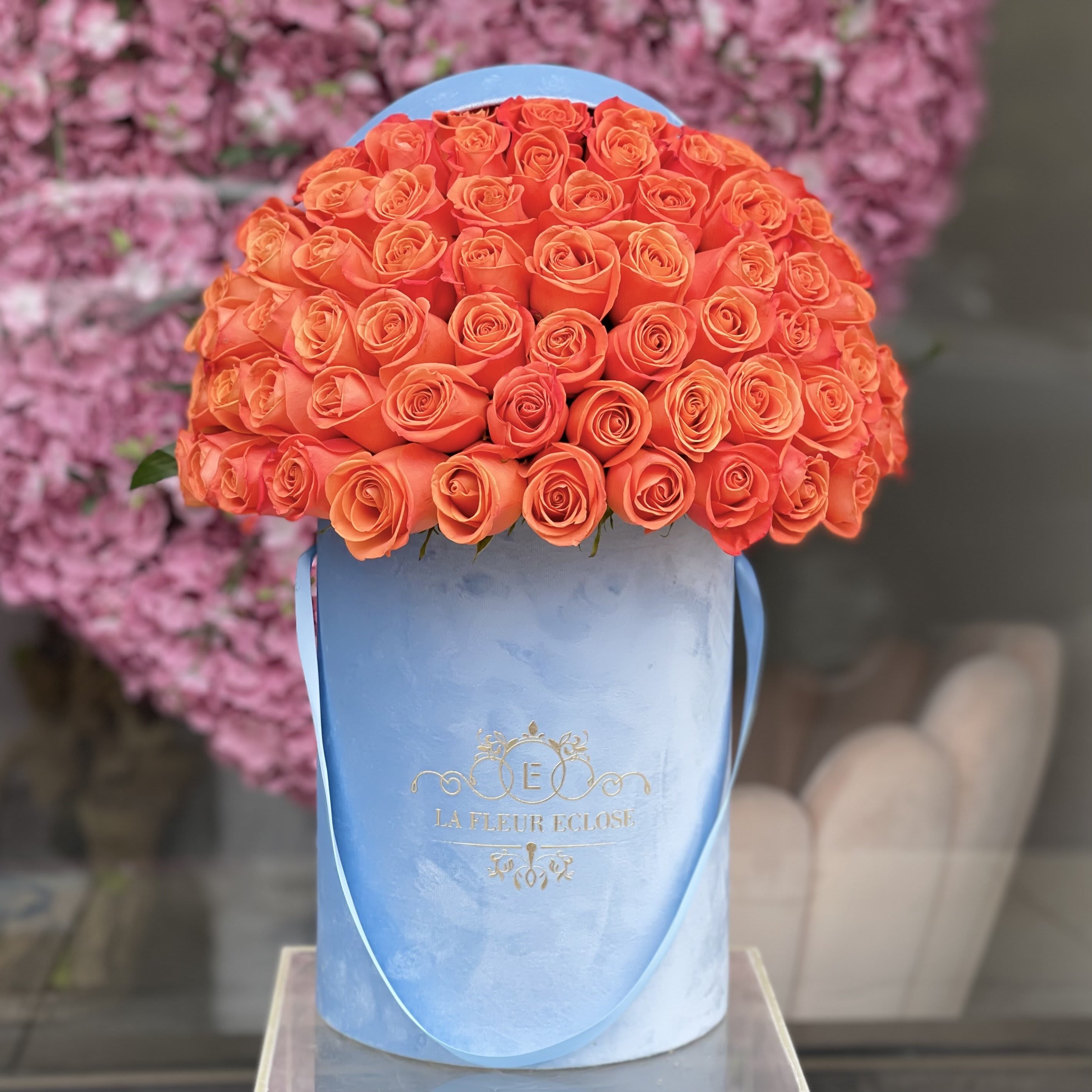 Hotel California - Standard 50 fresh cut  orange roses in our light blue velvet box Deluxe 75  fresh cut  orange roses in our light blue velvet box