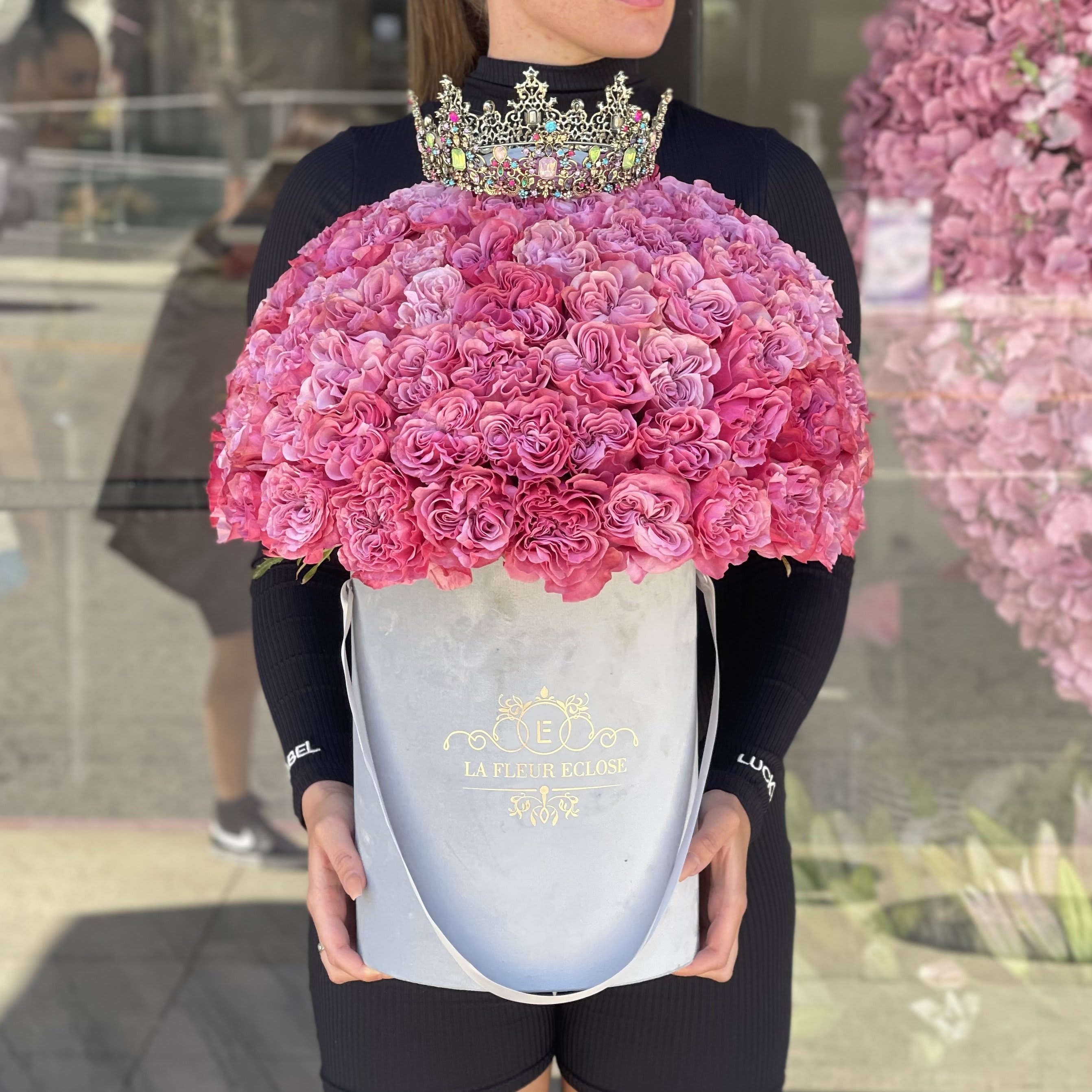 Pink rose bouquet in a pale blue box with a jeweled crown on top