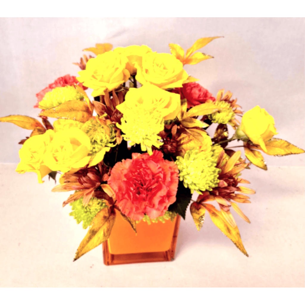 Yellow and coral flowers arranged in an orange square vase