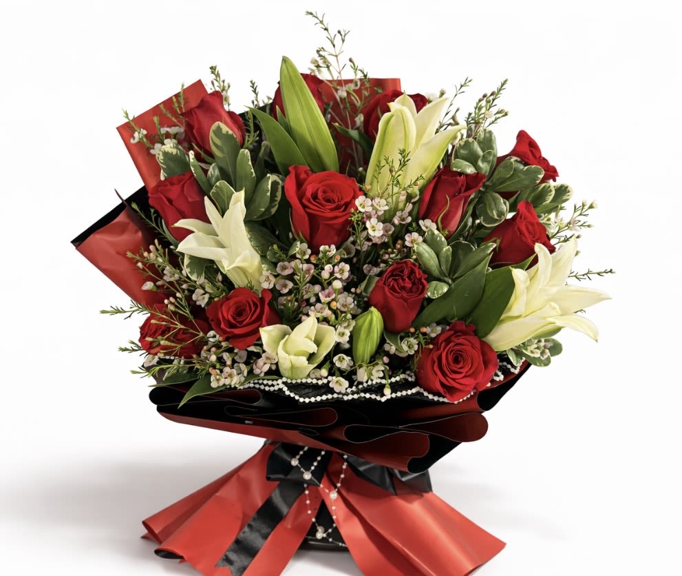 Bouquet of red roses and white lilies wrapped in red and black paper