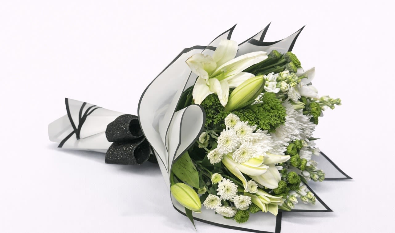 White lilies and green-white chrysanthemums wrapped in black-edged paper