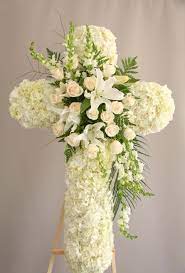 White floral cross arrangement with cascading blooms