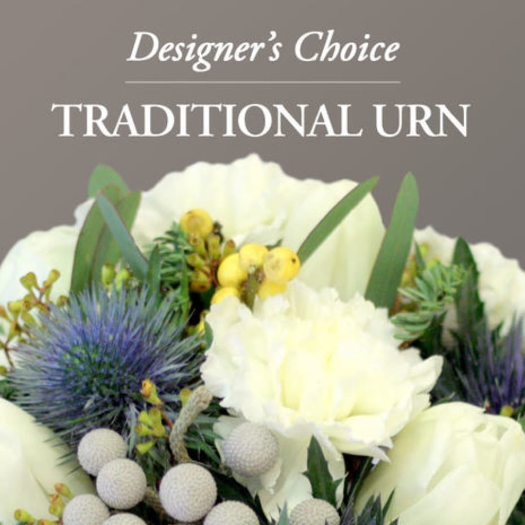 White floral arrangement labeled Traditional Urn with blue thistle and yellow berries