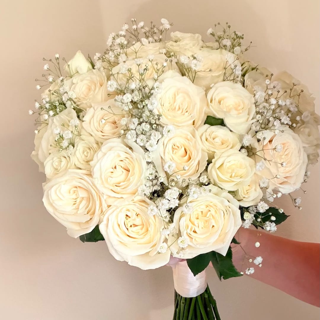 Cream rose bridal bouquet with baby's breath and white ribbon wrap