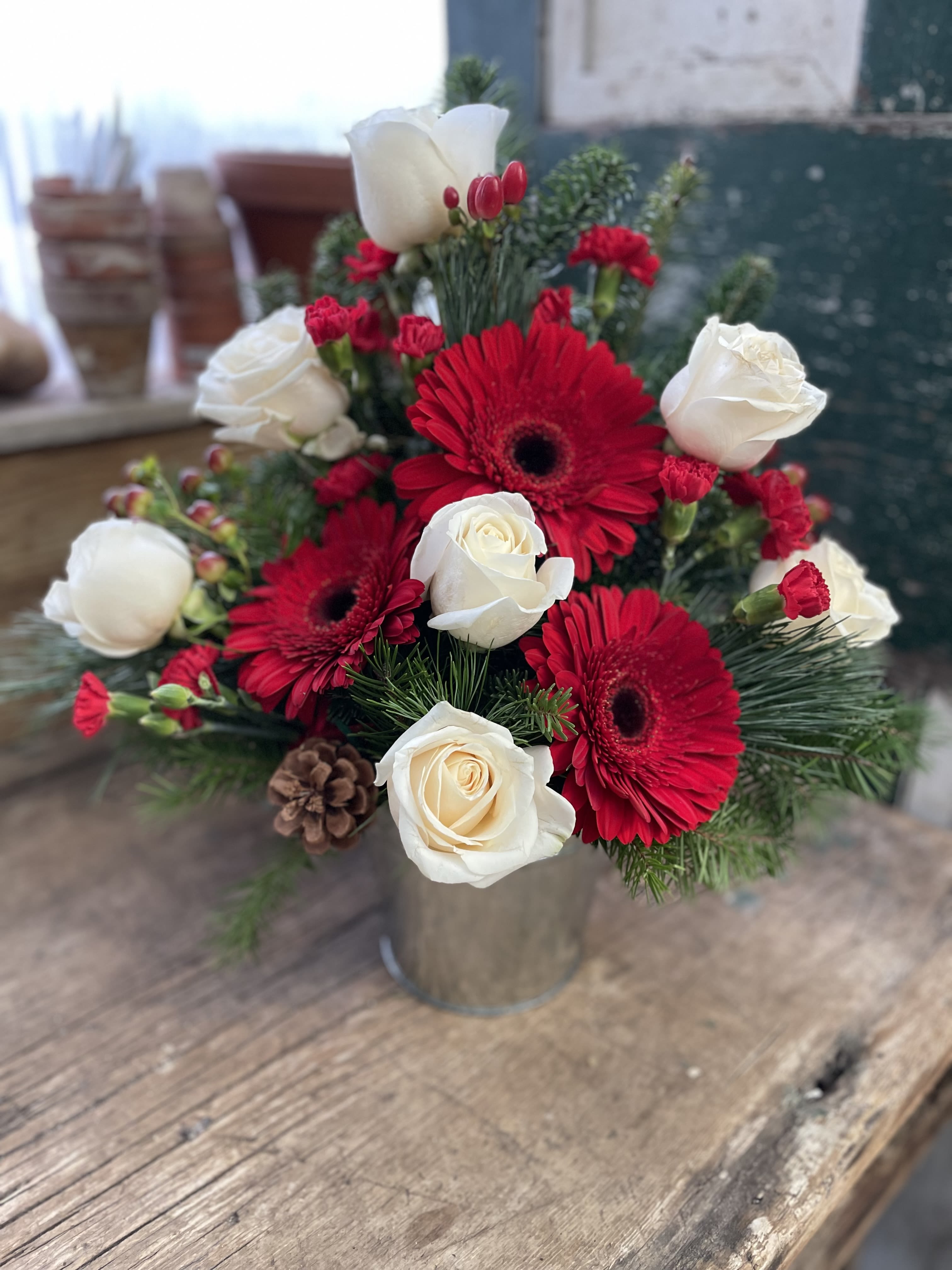 Red gerberas and white roses in a metal vase