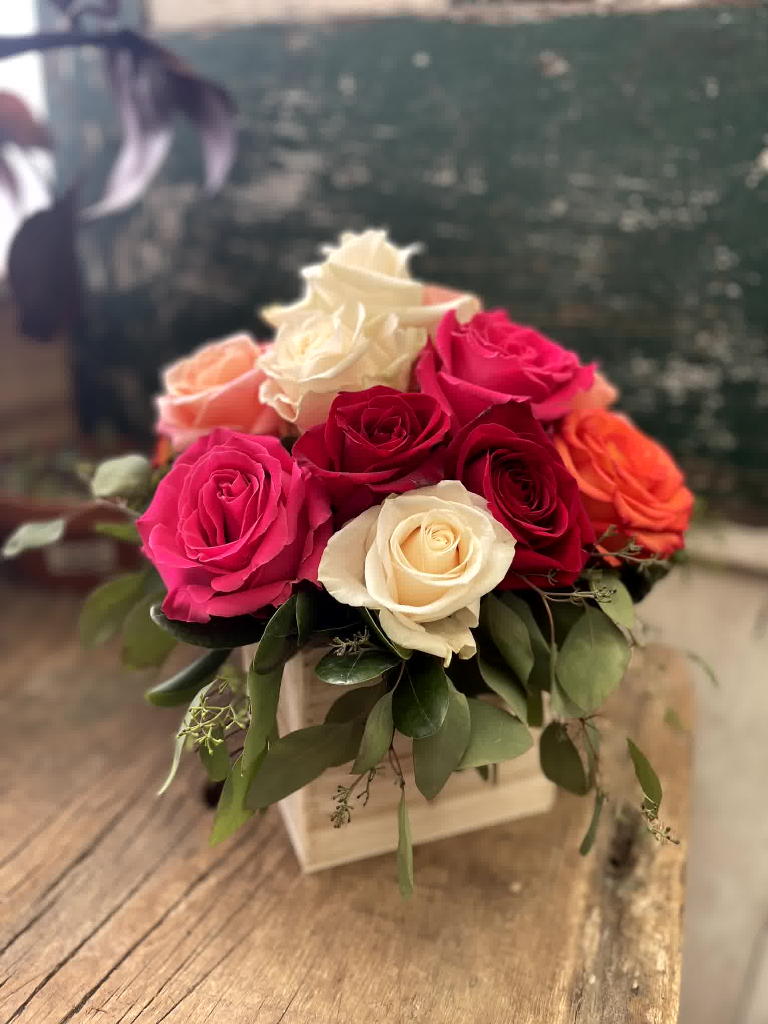Bouquet of pink, red, and white roses in a square box