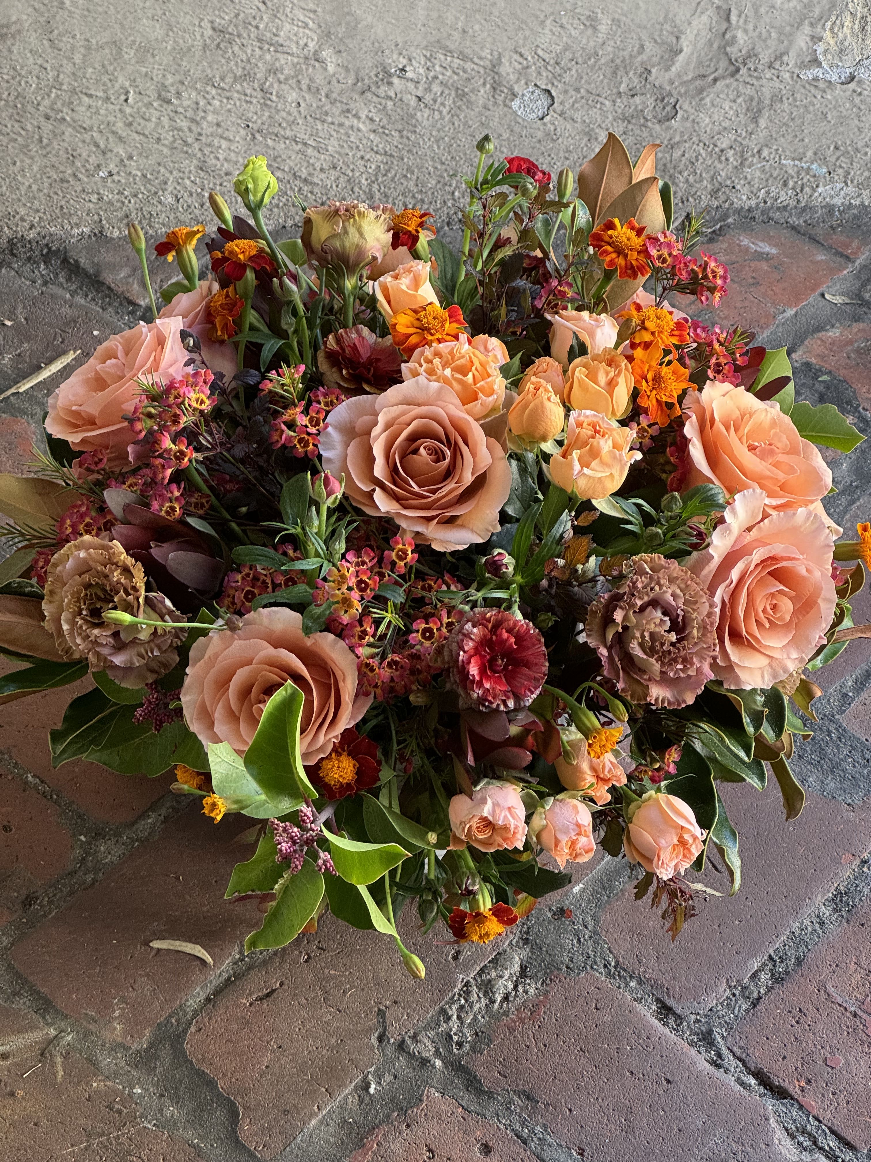 Peach and orange mixed bouquet with roses and small accent flowers