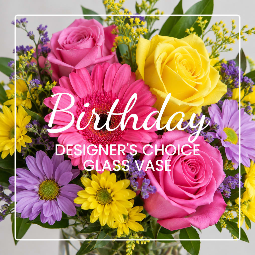 Mixed bouquet of pink and yellow roses with daisies in a glass vase