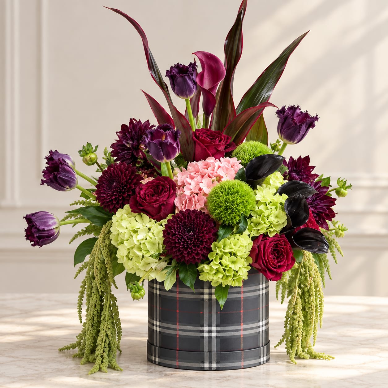 Mixed bouquet in a plaid hatbox with purple, pink, and green flowers