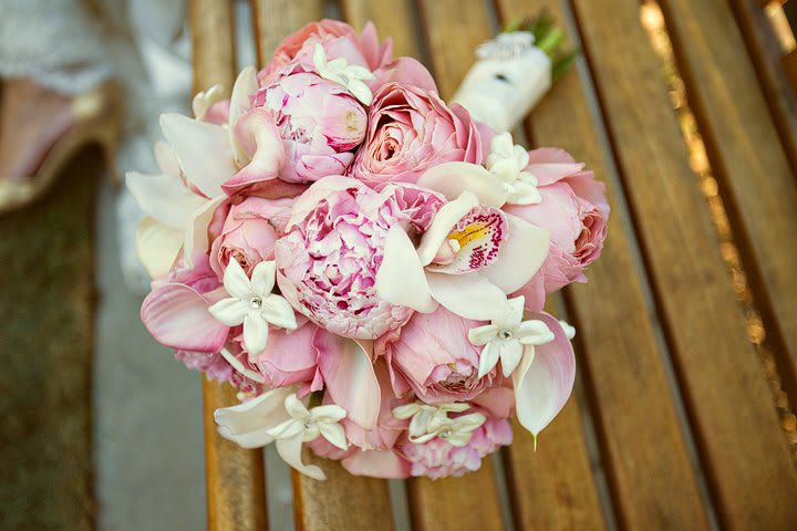 Pink and white bridal bouquet with roses and orchids