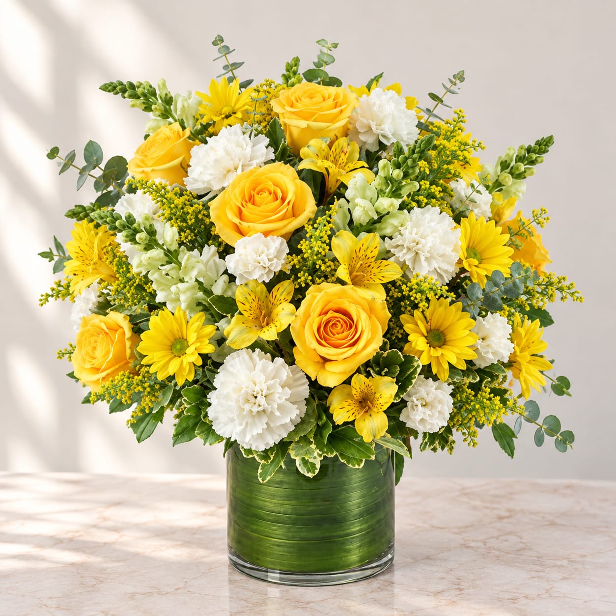 Yellow roses and white carnations in a green glass vase