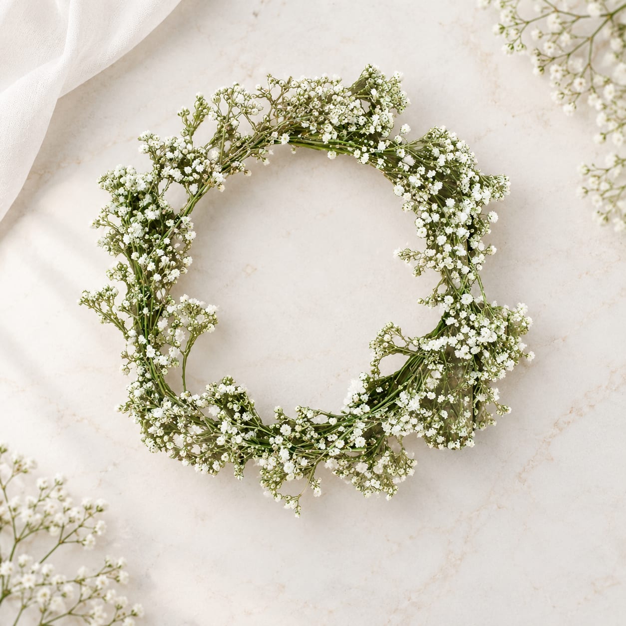 White baby's breath wreath on a light stone surface
