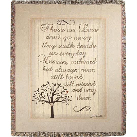 Framed memorial quote with a tree illustration on a woven throw blanket