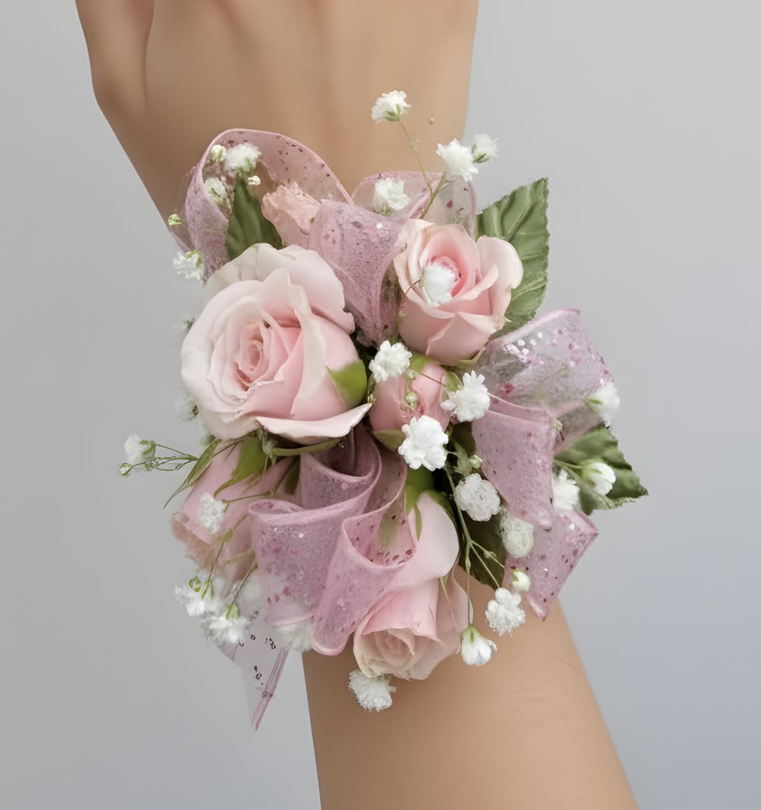 Pink Rose Corsage - Pink roses with baby’s breath and greenery, finished with a sheer pink ribbon.