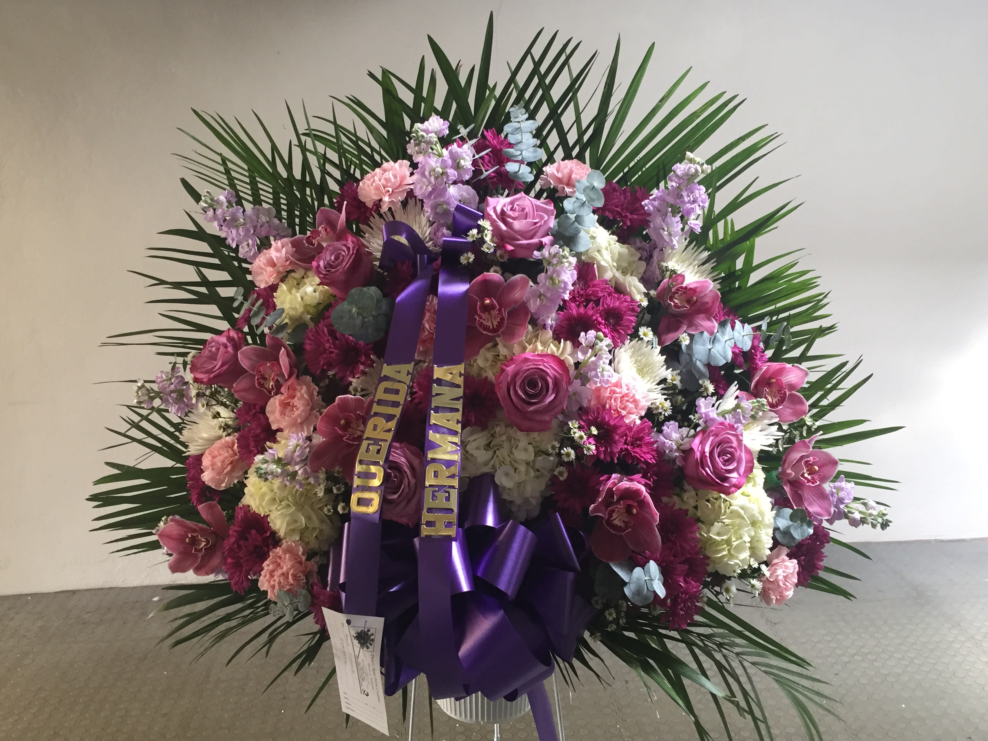 Large pink and purple floral standing spray with ribbon