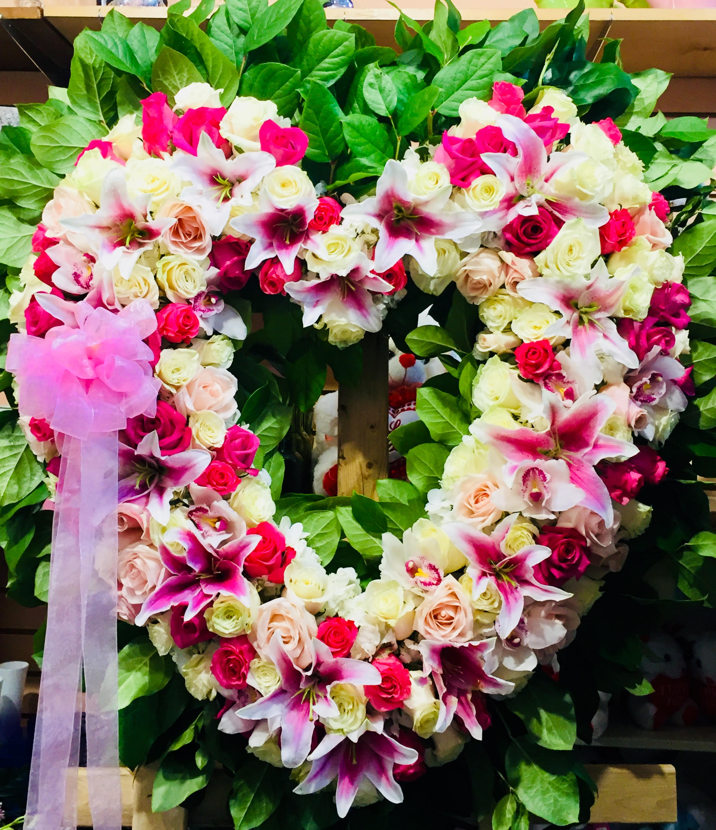 Heart-shaped floral wreath with pink and white roses and lilies