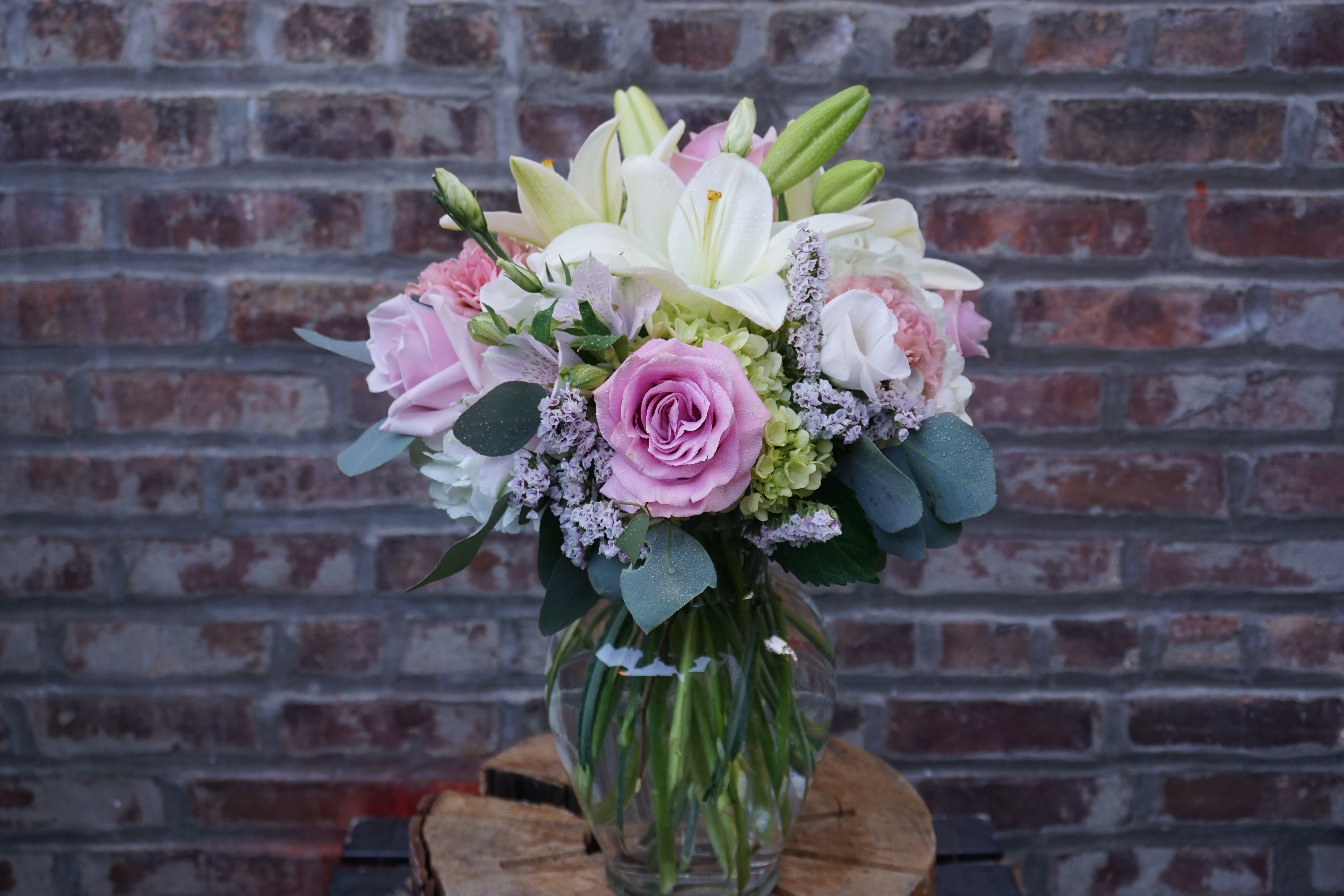 Pink and white bouquet in a clear glass vase