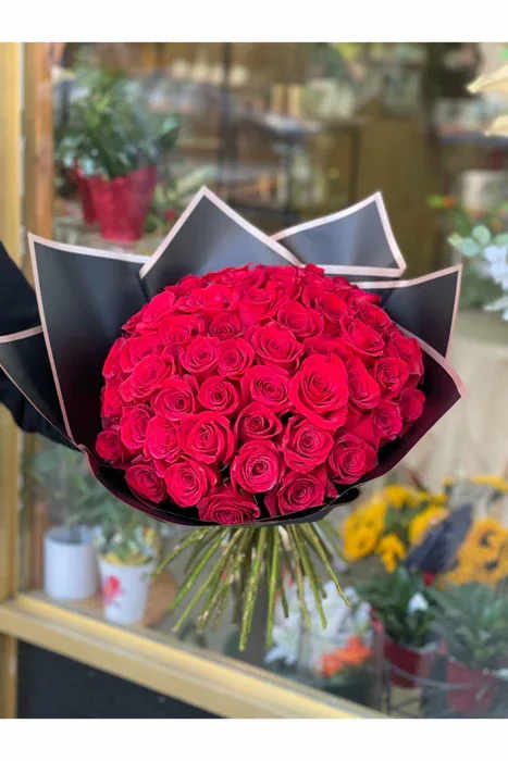Bouquet of red roses wrapped in black paper