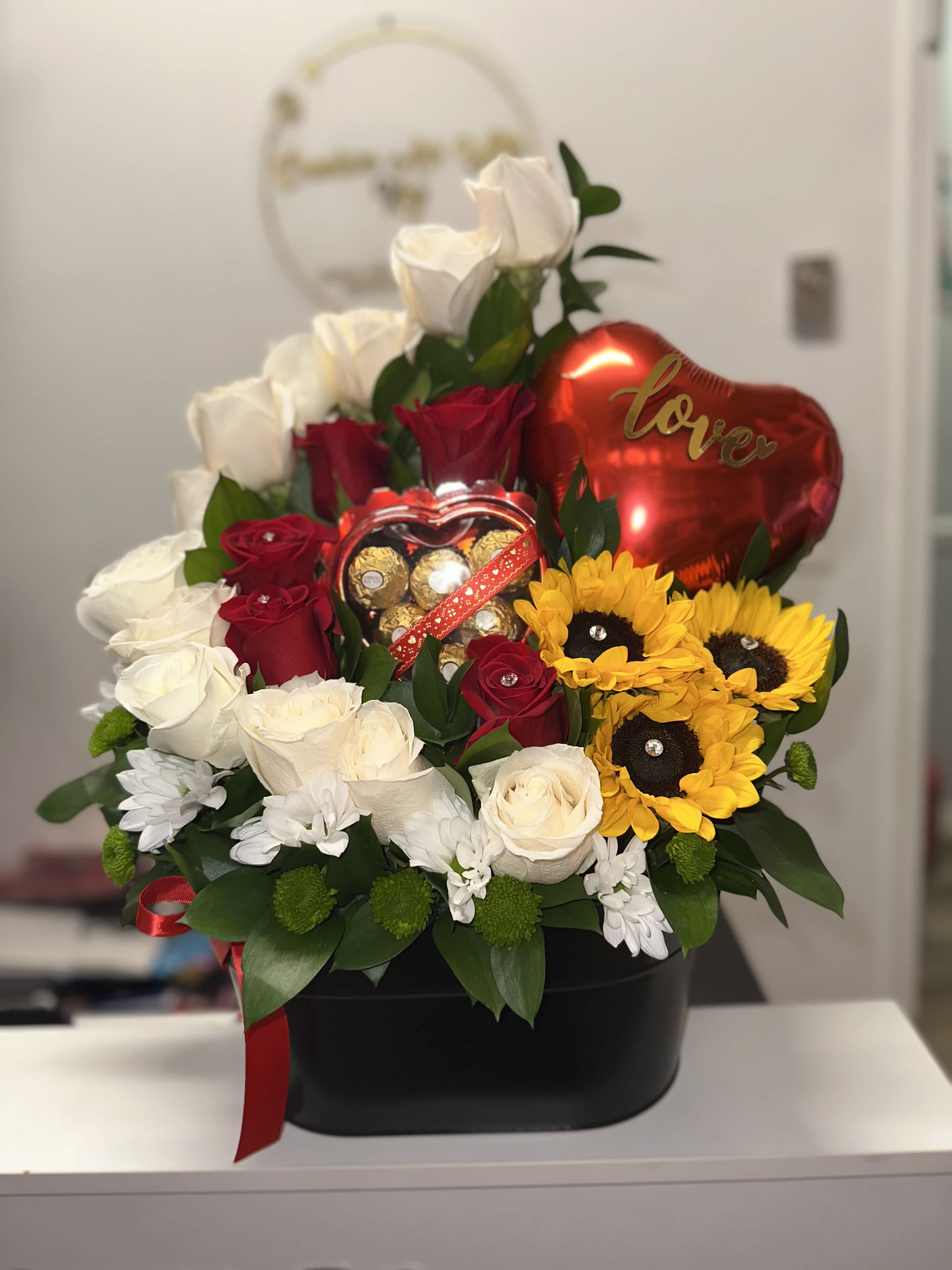 Bouquet of red and white roses with sunflowers and a heart balloon