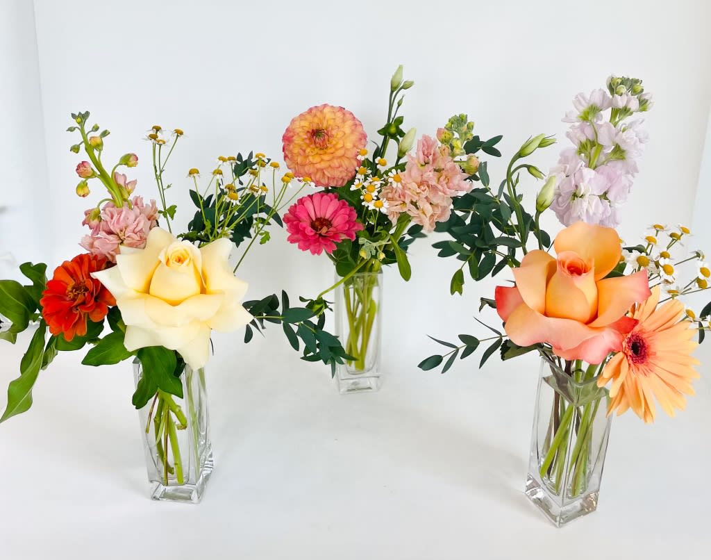 The Square Bud Vase - Seasonal blooms, hand selected by our designers.  Place one bud vase on each cocktail table, or use a grouping for your centerpiece.  Priced individually.  Our Recommendation: 5 per 60" table, or 7-9 per 8-10" table. Ok to substitute flowers for your own design, please contact us at store prior to purchase.