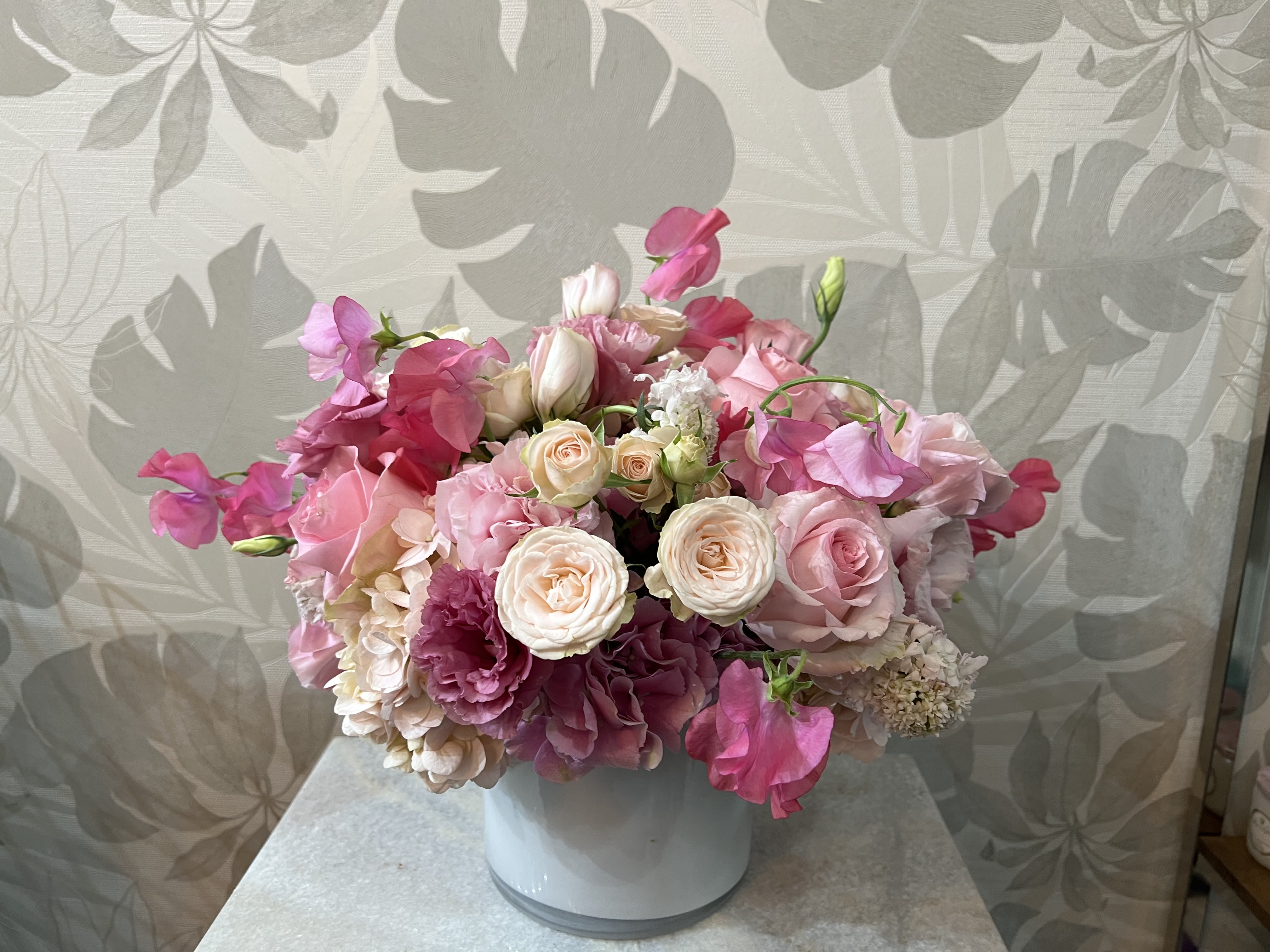 Pink and white bouquet in a white vase