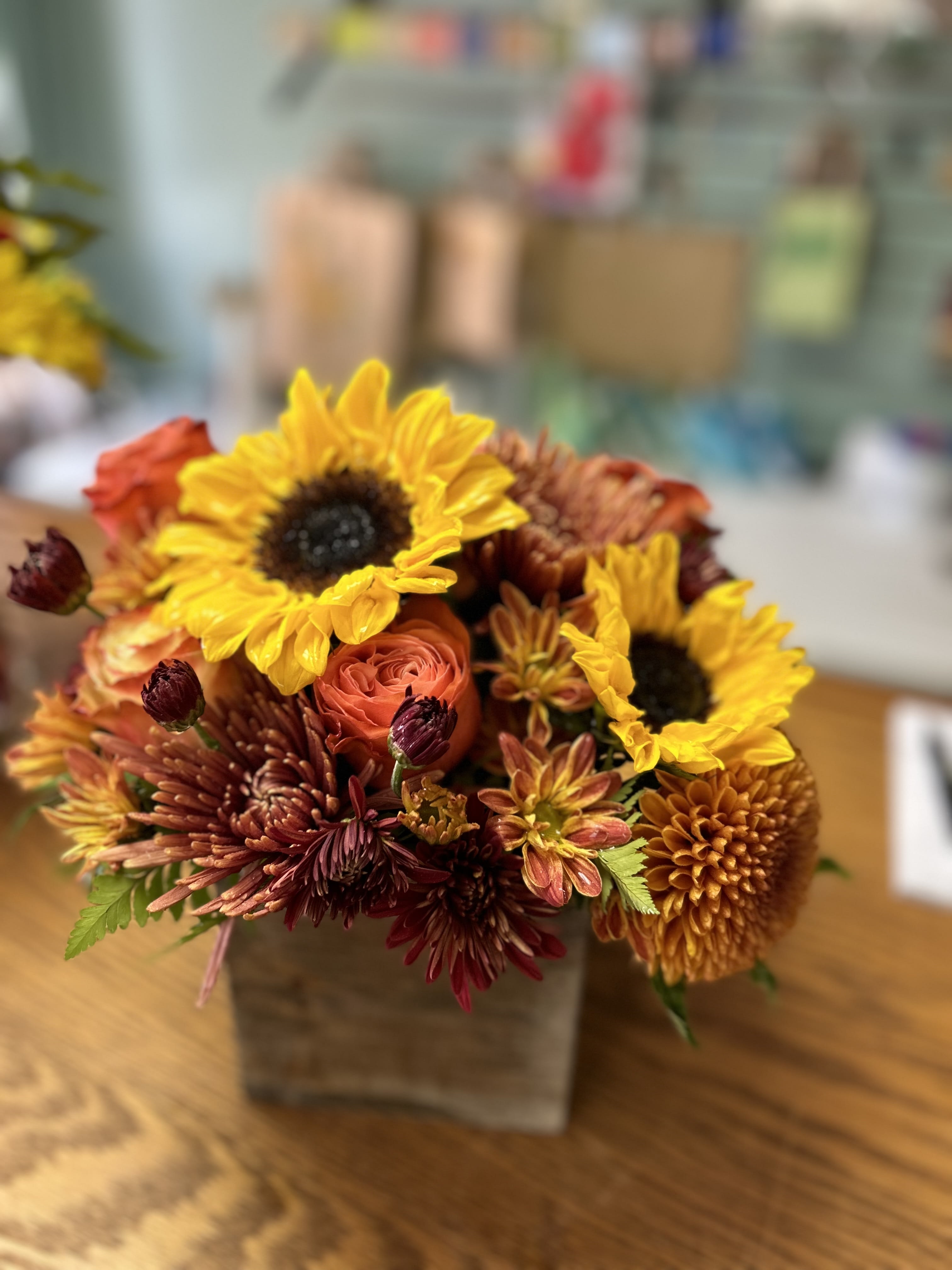 A little Fall Happy - This pretty wooden box features Sunflowers and assorted fall color roses and mums. Just a little something to let someone know you care.